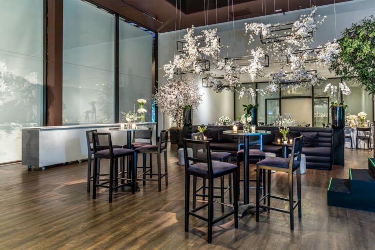 A beautiful indoor wedding venue with floral decorations and modern furniture.