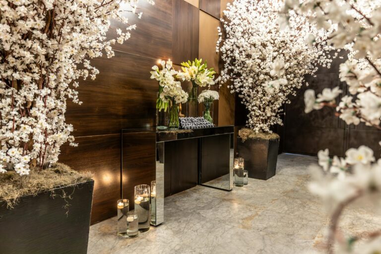 Chic indoor setting with blooming floral arrangements and elegant candle decor.